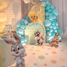 an image of a baby shower scene with bunny and other animals on the floor in front of balloons