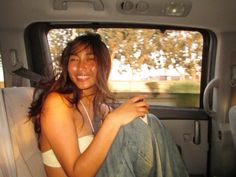 a woman sitting in the back seat of a car