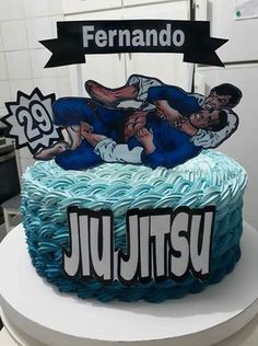 a cake that is decorated with two men wrestling on top of it, and the words jujitsu written in large letters