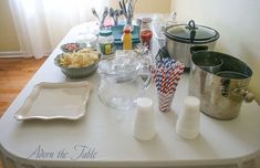 the table is set up with dishes and utensils for an appetizer