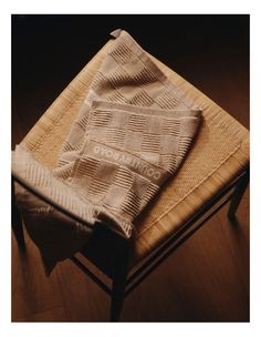 a blanket sitting on top of a wooden chair