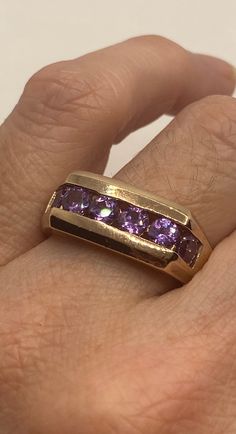 This is a vintage purple amethyst with amethyst sidestones set in golden 925 sterling We have in size 11 this can be sized to your specification, our jeweler charges $10-$20 please message us to discuss sizing your ring or engraving options. All of our jewelry is hand polished and shipped to you in a stylish gift box. We are happy to gift wrap for you. It is important to us that each customer be thrilled with their purchase. We are grateful for thousands of positive reviews. Classic Amethyst Birthstone Ring For Anniversary, Classic Purple Birthstone Ring With Center Stone, Classic Amethyst Purple Rings, Classic Purple Gemstone Birthstone Ring, Classic Purple Birthstone Ring With Gemstone, Vintage Purple Amethyst Ring For Anniversary, Classic Purple Ring For Anniversary, Formal Purple Amethyst Ring With Vvs Clarity, Classic Purple Rings For Anniversary