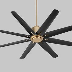 a ceiling fan with black and gold blades