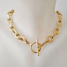 "A beautiful and unique gold plated necklace with a toggle clasp. This gold chain necklace has unique eye shaped links. Easy to match, this chunky gold  necklace will upgrade any outfit! This is a light weight necklace! links are hollow! Available in silver plating as well. Materials: 24 k gold plated brass chain and elements - matte/shiny finish  Silver plated brass chain and elements - oxidized finish Measurements: Chain width: 0.4\"/1.c\"m Clasp diameter: 0.8\"/2 c\"m Thickness: 0.12\"/3 m\"m Luxury Recycled Gold Tarnish Resistant Chain Necklace, Yellow Gold Chain Link Toggle Necklace, Elegant Chunky Toggle Necklace In Metal, Yellow Gold Toggle Necklace With Chunky Link Chain, Chunky Chain Metal Toggle Necklace, Metal Chain Link Toggle Necklace, Metal Toggle Clasp Chain Link Necklace, Gold Plated Necklace With Toggle Clasp, Gold Toggle Necklace With Oval Link Chain