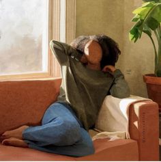 a painting of a woman sitting on a couch in front of a potted plant