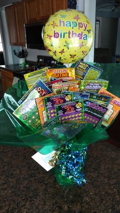 a bunch of birthday cards and balloons in a vase