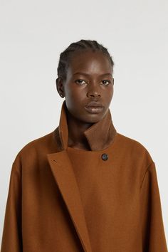 This coat is made from a wool and cashmere fabric woven in Italy near lake Lugano. The structured and slightly oversized cut was designed with precision. Details include raglan pockets, a concealed button packet with corozo buttons and a back vent. The inside of the coat is lined in viscose and the concealed part of the collar is made of mottled wool felt. WHY WE LOVE IT INDRESS was founded in Paris in 2001 by Dutch designer Wies Schulte with the desire to combine elegance, timeless shapes and v Brown Wool Coat With Lapel Collar And Concealed Placket, Brown Wool Coat With Concealed Placket For Winter, Oversized Brown Wool Coat For Work, Fall Cashmere Wool Coat With Concealed Placket, Brown Cashmere Outerwear With Button Closure, Structured Wool Coat With Concealed Placket For Fall, Brown Oversized Outerwear For Formal Events, Brown Oversized Outerwear For Formal Occasions, Oversized Brown Wool Outerwear