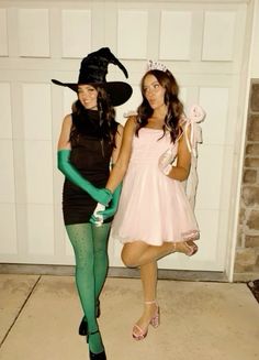 two girls dressed up in halloween costumes posing for the camera