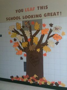 a bulletin board with fall leaves on it and a tree made out of magnets