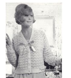 an old black and white photo of a woman wearing a sweater