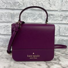 Brand New With The Tag Authentic Color Is Plum Pie Gold Hardware Saffiano Leather Metal Pinmount Logo Two Way Spade Jacquard Lining Interior: Back Credit Card Slots Exterior: Back Slip Pocket Flap With Magnetic Snap Closure 5.92"H X 6.48'w X 2.16"D Handle Drop: 3.25" Strap Drop: 22" Same Or Next Day Shipping! Chic Purple Handheld Satchel, Purple Square Box Bag For Shopping, Purple Shoulder Box Bag For Shopping, Purple Top Handle Box Bag For Travel, Purple Top Handle Box Bag For Daily Use, Purple Rectangular Bag With Dust Bag, Purple Square Shoulder Bag For Evening, Purple Rectangular Bag, Chic Purple Rectangular Satchel