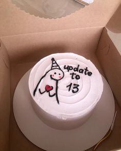 a birthday cake in a box with an image of a person holding a heart on it