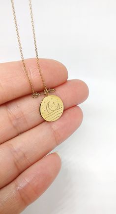 14mm 14K 9K Delicate Sun and Moon Necklace, Solid Gold Disc Necklace, Reversible 2 Sided Sun and Moon Pendant, Dainty Minimalist Layering necklace, 9K gold sun and moon necklace, Gift for her, FREE EXPRESS SHIPPING Beautiful and delicate necklace with a disc charm engraved with a crescent moon on the one side and a sun on the other. The necklace is made in 14K or 9K solid gold. She's Like the Sun and the Moon Because even on the cloudiest of days... And darkest of nights... She still find the wa Minimalist Yellow Gold Charm Necklace With Moon Phase, Minimalist Yellow Gold Moon Phase Charm Necklace, Minimalist Gold Charm Necklace With Sun And Moon Design, Everyday Round Charm Necklace With Moon Phase, Sun And Moon Pendant, Sun And Moon Necklace, Gold Disc Necklace, Diamond Evil Eye, Zodiac Bracelet