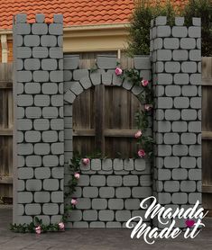 a gate made out of cinder blocks with pink roses on it and the words manda made it