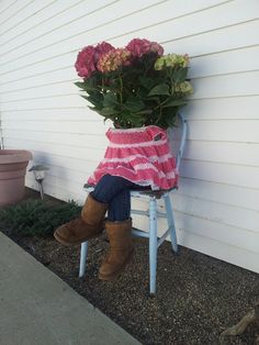 a woman is sitting on a chair with flowers