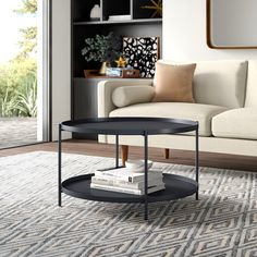 a living room with a couch, coffee table and bookshelf on the floor