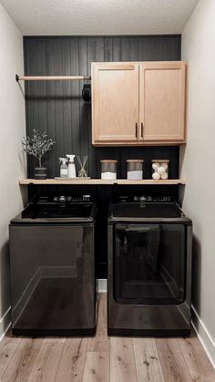 a black stove top oven sitting inside of a kitchen next to a wooden cabinet above it