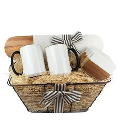 two coffee mugs in a basket with wooden spoons