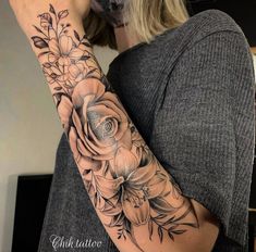 a woman with a flower tattoo on her arm