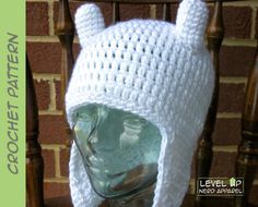 a white crocheted hat with ears on top of a head