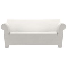 a white couch sitting on top of a white floor