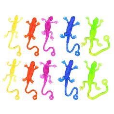 small plastic geckos in different colors on a white background