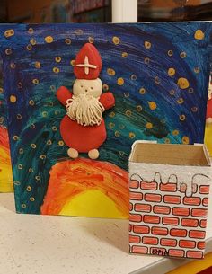 an art project made out of cardboard and paper with a painting of a gnome on it