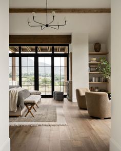 a living room filled with furniture and a large glass door leading to a patio area