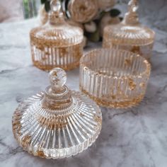 three clear glass dishes on a marble table