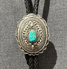 Gorgeous fine Navajo large oval sterling silver concho bolo tie with a lovely piece of Fox turquoise, by Leonard Maloney, Navajo/Dine' Native American Indian... Classic... Sculptural, with complex silver work, including overlay, hand stamps, scalloped edges & oxidized patina. With sterling silver tips. Just beautiful! Artist hallmark & sterling stamps on backside. Etsy Silver Tips, Silver Work, Scalloped Edges, Native American Indians, American Indian, Hand Stamped, Hallmark