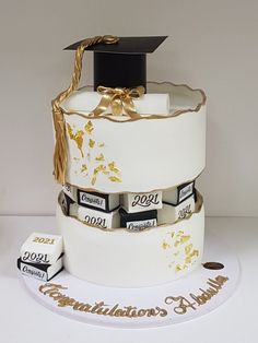 a graduation cake is decorated with gold foil