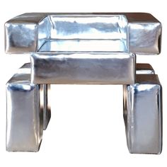 a shiny silver chair with two legs