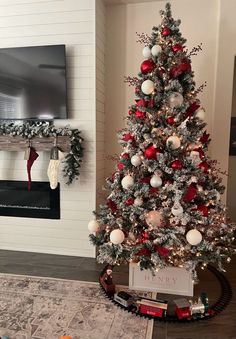 a christmas tree is decorated with red, white and silver ornaments