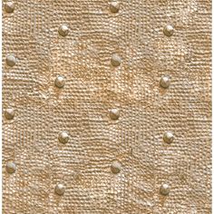 an upholstered fabric textured with rivets and circles in gold color