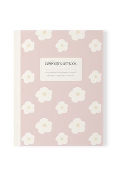 a pink notebook with white flowers and the words composition notebook on it