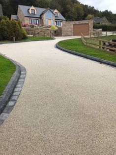 an empty driveway in front of some houses