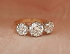 After a long search, I have found this sensational old cut diamond trilogy for the store. Large old cut diamond trilogies such as this are so popular and I am delighted to present this ring for sale in mint condition. Graded 'Twentieth Century' by the Guild of Valuers & Jewellers, to my eye she would settle comfortably into the mid Century period. This was an era of exceptional jewellery production and this piece does not disappoint. This trilogy features an impressive 2.56ct of old brilliant cu Luxury Vintage Three Stone Diamond Ring, Antique Trilogy Engagement Ring, Vintage Trilogy Ring, Family Heirloom Engagement Ring, Luxury Victorian Three-stone Diamond Ring, Antique 14k Gold Three-stone Diamond Ring, Diamond Trilogy Ring, Trilogy Engagement Ring, 23 September