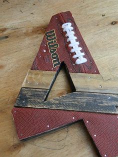 a football themed wooden letter shaped like a star with a football on it's side