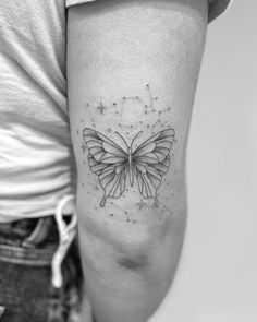 a woman's arm with a butterfly tattoo on the left side of her body