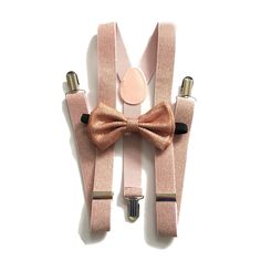 "Look dapper for all the festivities you're attending this season with the suspenders and bowtie set! They also look excellent and timeless in photography. ★color: Rose gold suspender and bow tie set ★suspenders size measurement fits children ages 5 and up, teens and adults (will fit taller men up to 6'3 tall as well) full length 45 inches width 1 inch ★size of bow: 2.5 inches (height) and 4.5 inches (width) adjustable black neck strap fits neck sizes 13.5\" to 18\" ♥ Want to see more? Please cl Elegant Party Belt With Bow, Fitted Belts And Suspenders With Bow For Party, Adjustable Gold Bow Tie For Party, Elegant Adjustable Gold Belts And Suspenders, Rose Gold Bridal Party, Gold Suspenders, Gold Bowtie, Rose Gold Tie, Peach Bow Tie