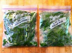 two bags of green leafy vegetables sitting on top of a wooden table next to each other