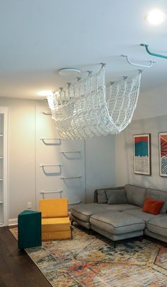 a living room filled with furniture and a chandelier hanging over the top of it