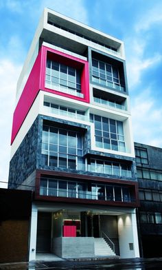 an apartment building with red and white accents