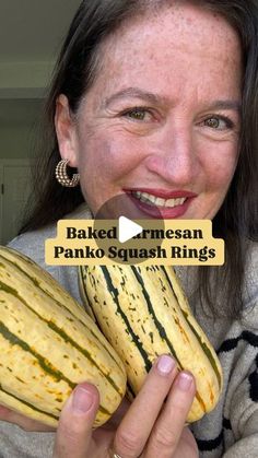 a woman holding up a large squash in front of her face with the caption baked rmmesan panko squash rings