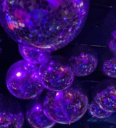 many shiny disco balls hanging from the ceiling