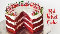 a red velvet cake with white frosting and strawberries on top