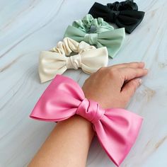 Our Satin Bow Tie Hair Scrunch is made from high quality satin, this scrunchie adds a charming and sophisticated detail to any hairstyle. Perfect for both casual and formal events, this scrunch is a must-have for a polished and stylish appearance.Dimensions: The bow is approximately 5.5" x 3" x 1"Made In: ChinaMaterial Composition: high quality satin Bow Tie Hair, Bow Scrunchie, Tie Hair, Hair Setting, Satin Bow, Satin Material, Dress Jewelry, Scrunchie Hairstyles, Hair Accessories Headbands