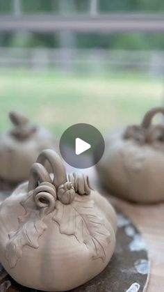 clay pots sitting on top of a wooden table