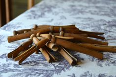 a pile of wooden sticks sitting on top of a white and blue tablecloth covered table