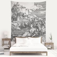 a large tapestry hanging on the wall above a bed